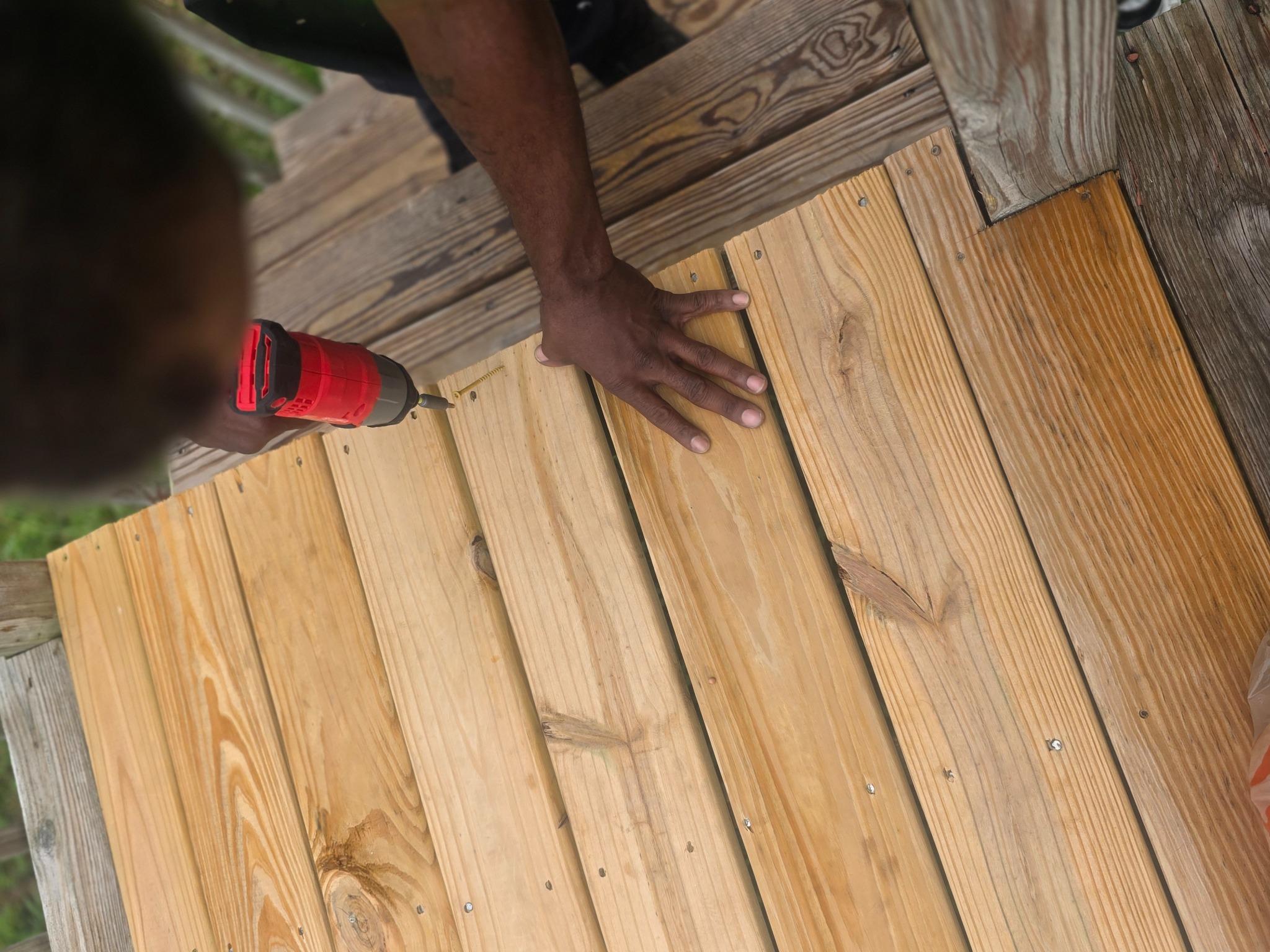 Replacing wooden deck boards during a deck repair project