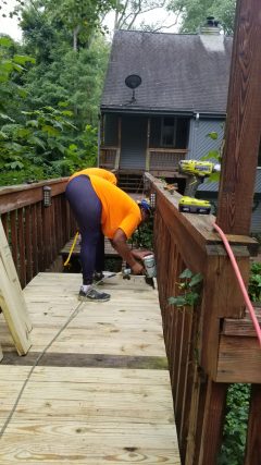Replacing boards on a raised wooden deck walkway