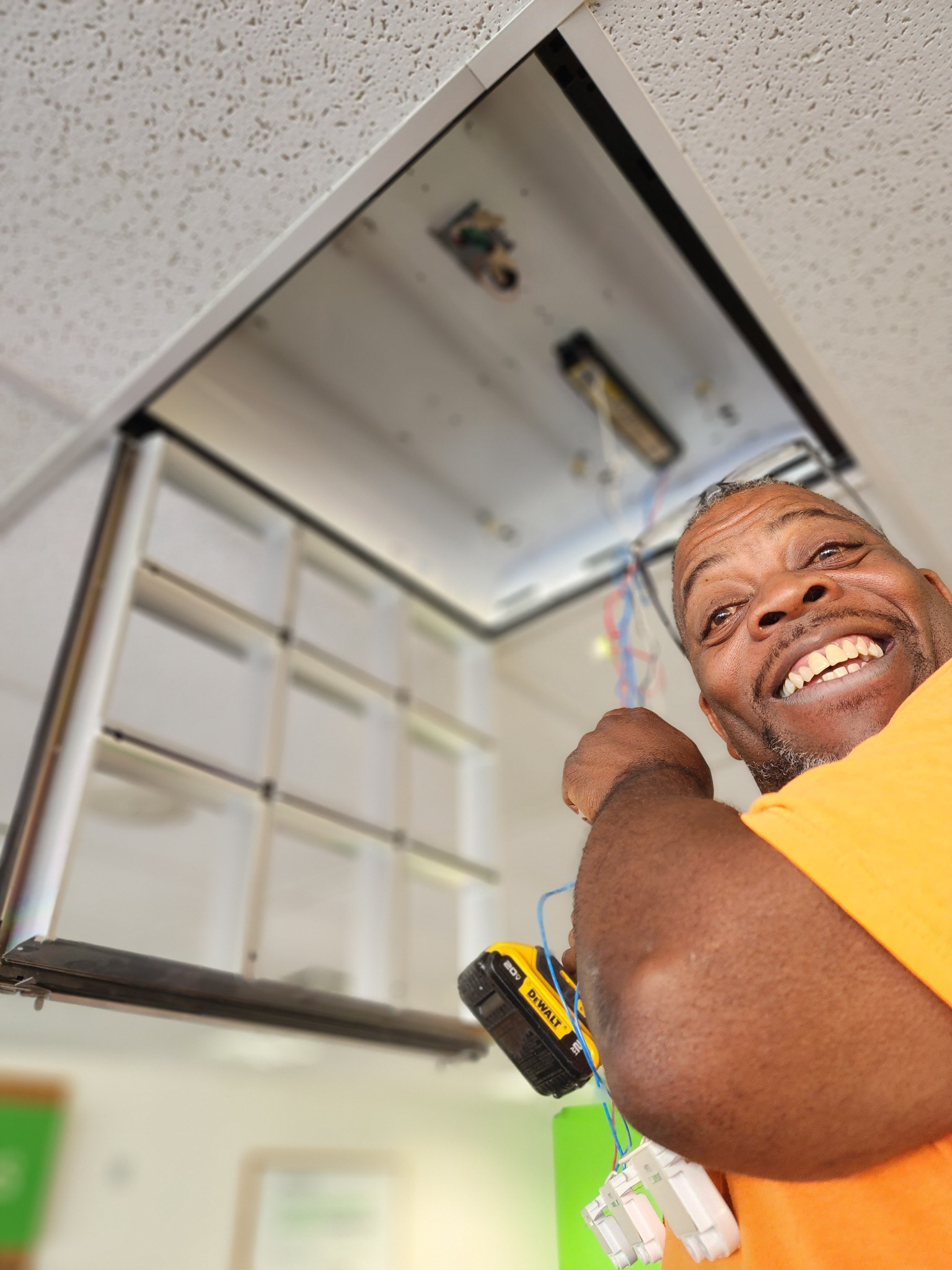 Gotta Love That Handyman working on an overhead home fixture